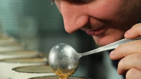 Man allows fragrant steam to rise with each motion of spoon Stock Footage 264350632