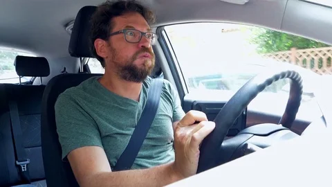 Man almost getting into accident texting message while driving car Stock Footage 76675406
