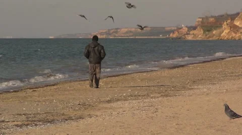 Man alone is on the beach, flying doves. Slow motion. Stock Footage 53164963