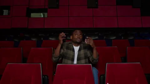 The man is alone in the cinema, he is indignant and leaves the hall, the film is Stock Footage 267349961
