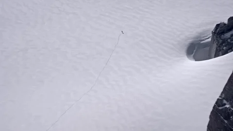 Man alone goes through the snowy mountains Stock Footage 104835522