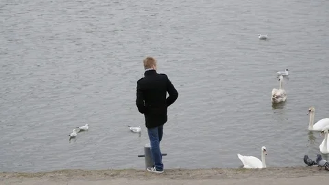 Man alone on the riverbank Stock Footage 73595085