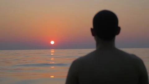 A man alone in the sea watches the sunset, in Koh Kong, Thailand Stock Footage 236647859