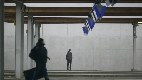 A man, alone waits for a train, by himself. SBB Bern, Train Station. Stock Footage 178708174