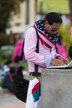 Man with American flag working in the square, Otavalo Stock Photos