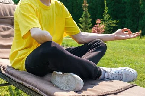 Man with amputated arm exercising with rubber elastic band outdoors Stock Photos