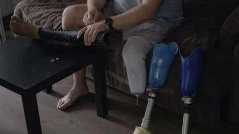 Man with Amputated Limb Preparing and Adjusting Prosthetic Device Stock-Footage 317899714
