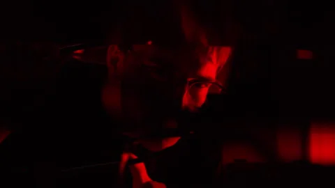 Man analysing servers in a data center with flashing red lights Video stock 287406235