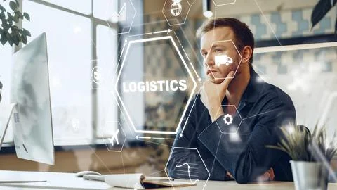 Man analyzes logistics data while working at a computer in an office environment 写真素材