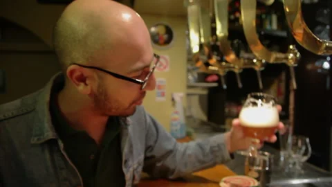 Man Analyzing Craft Beer in Glass And Drinking at Bar Counter Handheld Shot 스톡 동영상 346701385