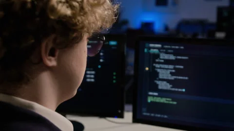 Man Analyzing Cybersecurity Code on Computer Monitor in Office Stock-Footage 347286495