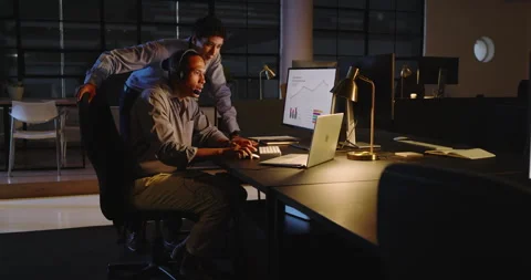 Man analyzing data on computer with colleague in modern office Stock Footage 315966717