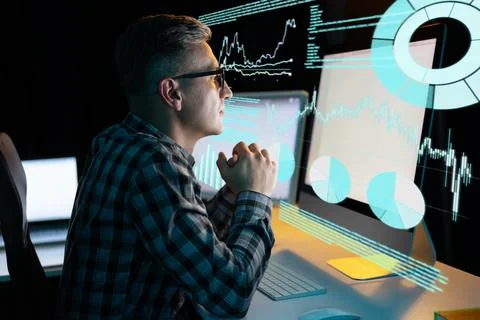Man Analyzing Data on Computer with Graphs and Charts in Background Stock-Fotos