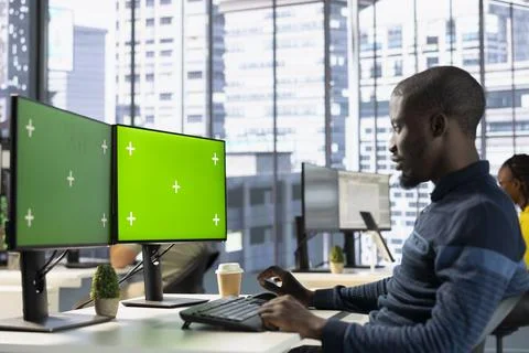 Man analyzing data on green screen computer Stock Photos
