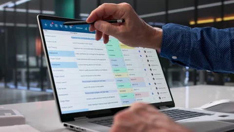 Man Analyzing Data On Laptop In Office Stock Footage 329308302