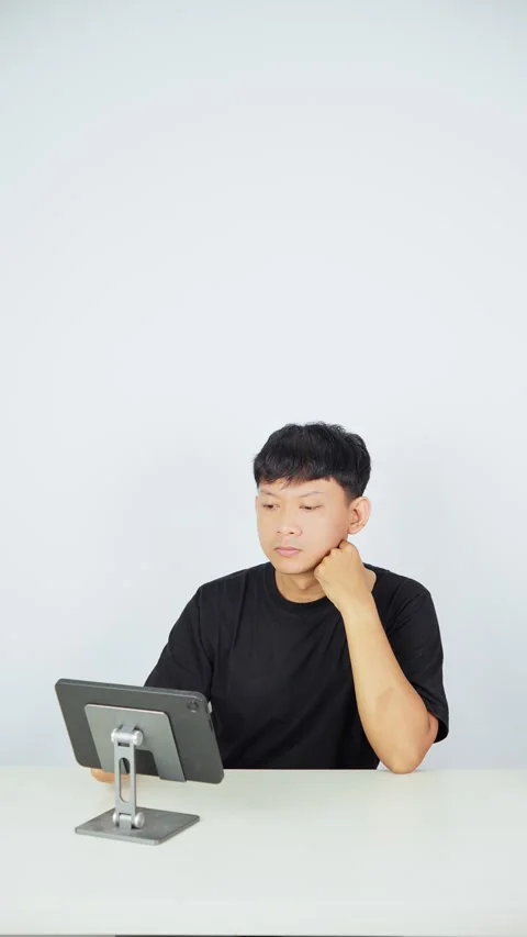 Man Analyzing Data on Tablet Against White Background Video stock 347105702