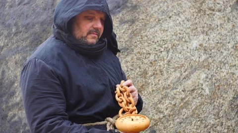 Man in ancient clothes keeping fast running clock -  time concept Stock Footage 104565166