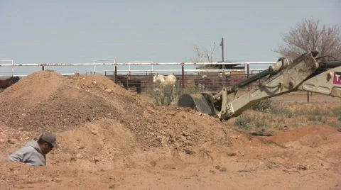 Man and Backhoe Working Together on Septic Stock Footage 547770