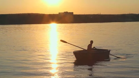 Man and boat at sunset Stock Footage 71656689
