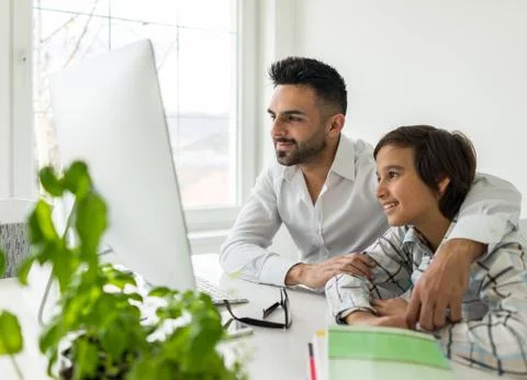 Man and boy on computer Stock Photos