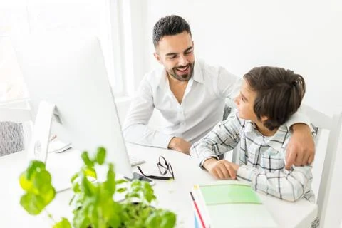 Man and boy on computer Stock Photos