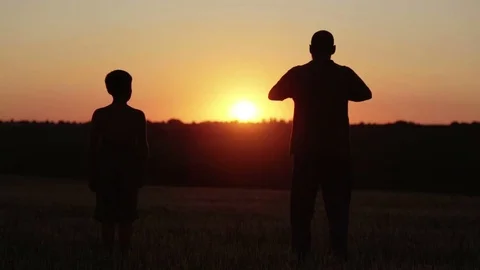 Man and boy in the field at sunset run and play. Stock-Footage 77570423