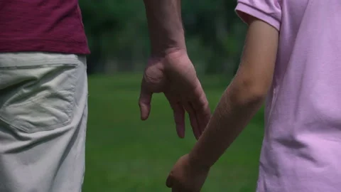 Man and boy holding hands and walking Stock Video Pond5