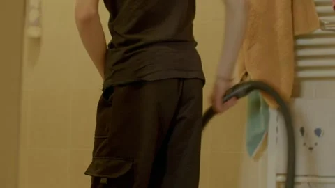 A man and boy interact in a bathroom, focusing on cleaning and reflection Stock Footage 311205426