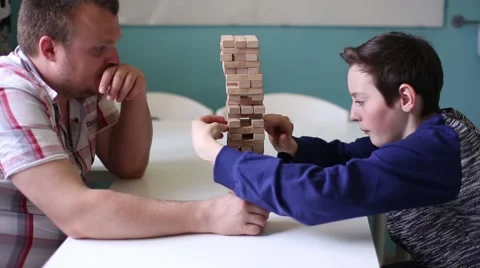 Man and Boy Playing in Board Game at the Table Stock Footage 52230523
