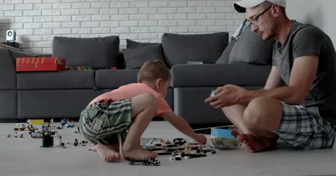 Man and a Boy Playing With Lego Cubes Stock Footage 65635708