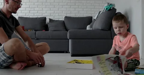Man and a Boy Playing With Lego Cubes Time-Lapse Stock Footage 65635816