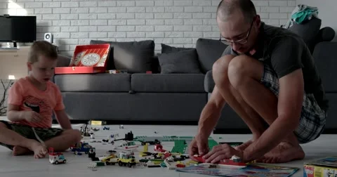 Man and a Boy Playing With Lego Cubes Time-Lapse 動画素材 65636178