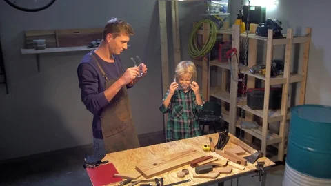 Man and boy put on safety glasses before work Stock Footage 126717353