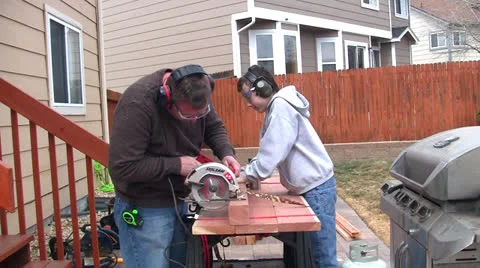 Man and boy sawing Stock Footage 22748077