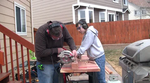 Man and boy sawing Stock-Footage 22752685