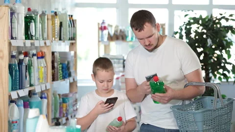 Man and boy scanning qr code for dishwashing detergent Stock Footage 310319181