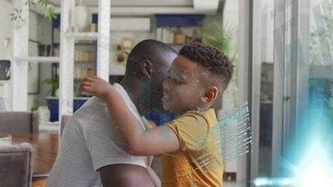 Man and boy sharing hug after holo tech UI appearing, showing charts and code Stock Footage 333704824