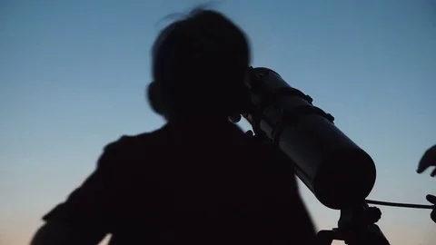 Man and boy using telescope Stock Footage