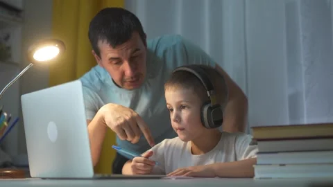 Man and boy working on laptop. Father learning distance with laptop. Child helps Stock Footage 317690898