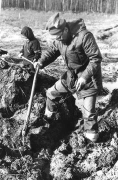 Man and child digging soil with shovel in field black and white Stock Photos
