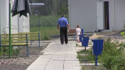 Man And Child In Modular House Camp. Mobile Home Container Stock Footage 70891577