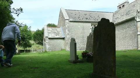 Man and child walking by old church Stock Footage 40720347