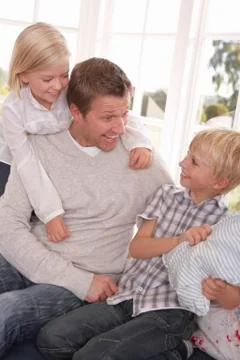 Man and children play together Stock Photos