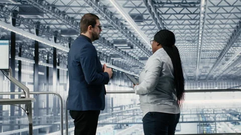 Man and coworker in microchip smart factory developing advanced electronics Stock Footage 333385063