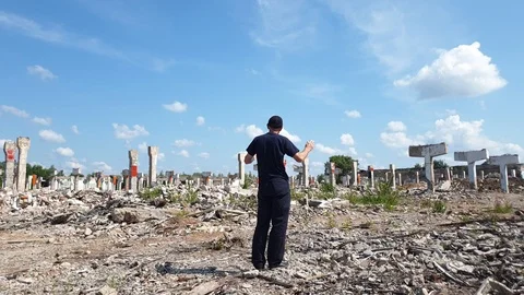 The man and the destroyed building. Man and ruins. Collapsed building. Stock Footage 113088978