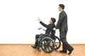 The man and a disabled with papers gesturing on the white wall background Photo