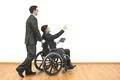 The man and a disabled with a tablet gesturing on the white wall background Photo