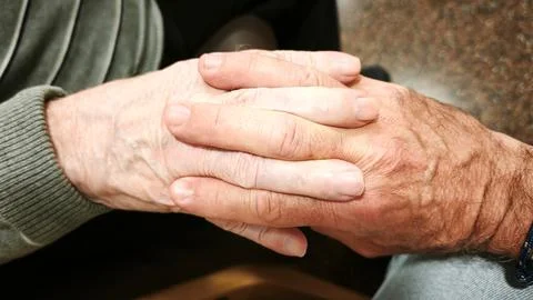 A man and an elderly man hold hands. Concept of help, collaboration. Stock-Fotos