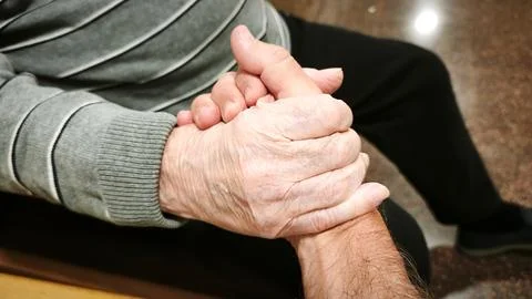 A man and an elderly man hold hands. Concept of help, collaboration. Stock-Fotos