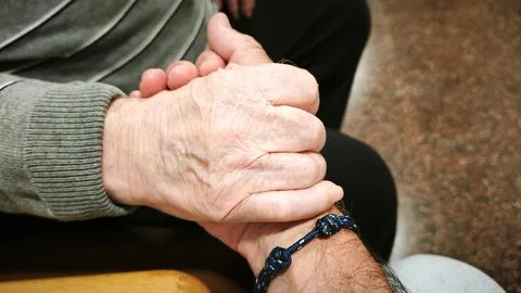 A man and an elderly man hold hands. Concept of help, collaboration. Stock-Fotos